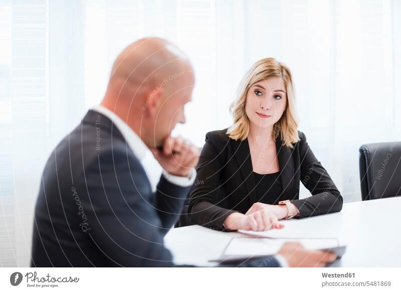 Businessman and businesswoman in conference room office offices office room office rooms businesswomen business woman business women Business man Businessmen