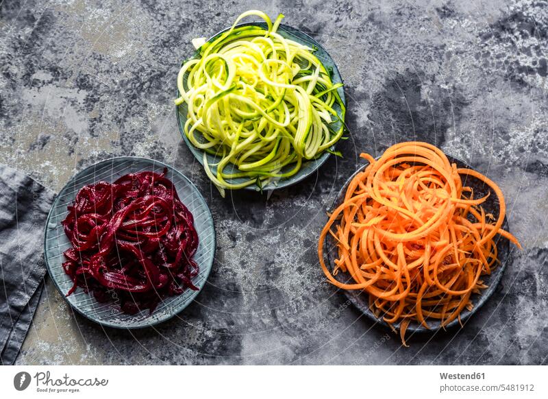 Bowl of Zoodles and bowls of carrot and beetroot spaghetti uncooked vegetable noodles orange carrot spaghetti Zucchini Noodles zucchini spaghetti Carrot Carrots