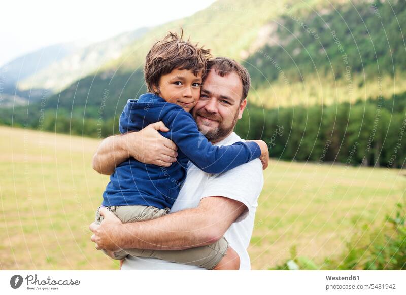 Portrait of father and little son hugging each other pa fathers daddy papa embracing embrace Embracement sons manchild manchildren parents family families