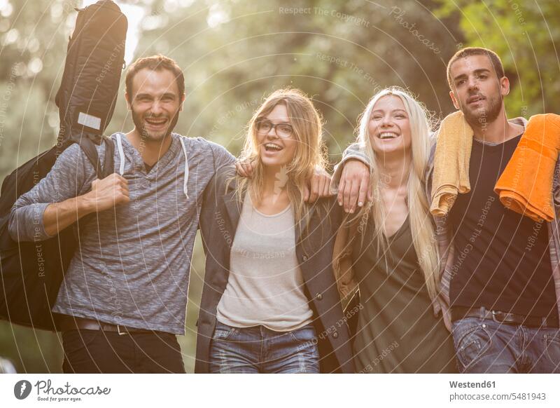 Four happy friends in the forest happiness laughing Laughter woods forests friendship positive Emotion Feeling Feelings Sentiments Emotions emotional community