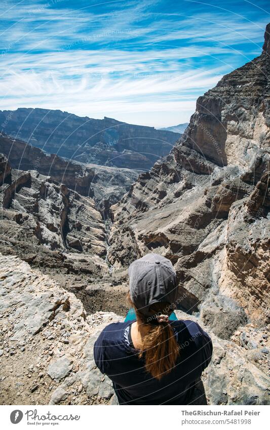 Woman sits at the edge of the canyon and enjoys the vastness Oman Sky Nature Colour photo mountain panorama Vantage point Panorama (View) Dry Hot travel Tourism