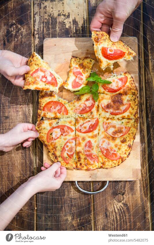 Hands taking pieces of homemade pizza with cauliflower and tomatoes Pizza Pizzas Food foods food and drink Nutrition Alimentation Food and Drinks hand