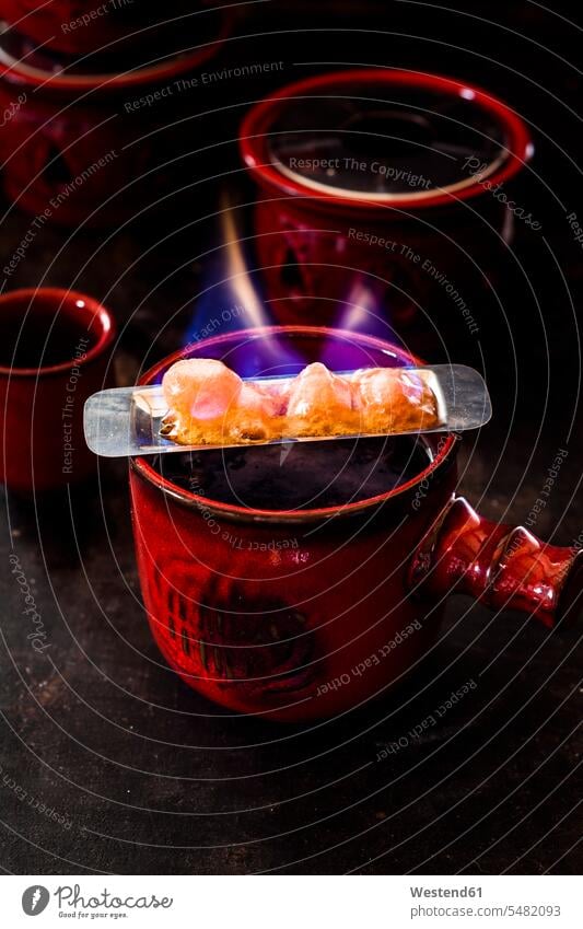 Preparing Feuerzangenbowle food and drink Nutrition Alimentation Food and Drinks motion Movement moving metal metals metallic focus on foreground