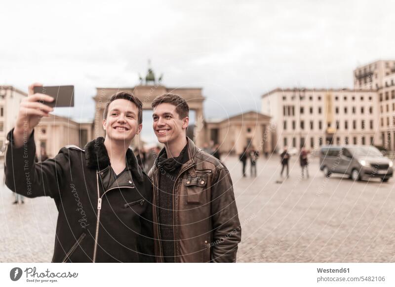Two teenagers taking a smartphone image of themselves in front of the Brandenburg Gate in Berlin wireless Wireless Connection Wireless Technology