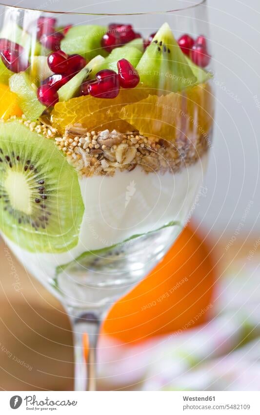 Yogurt with fresh fruit and muesli in a glass Glass Drinking Glasses natural yoghurt plain yoghurt pomegranate seed pomegranate seeds ready to eat ready-to-eat