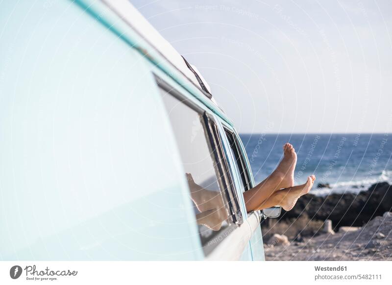 Spain, Tenerife, legs of woman leaning out of car window foot human foot human feet people persons human being humans human beings Sea ocean parked vacation
