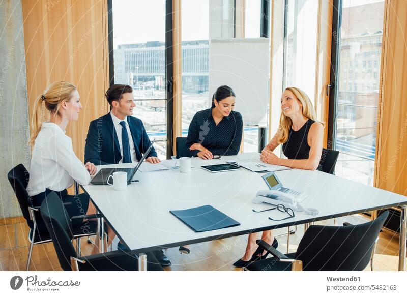 Business meeting in conference room businesswear business attire business clothing talking conversations smiling smile technology technologies Technological day