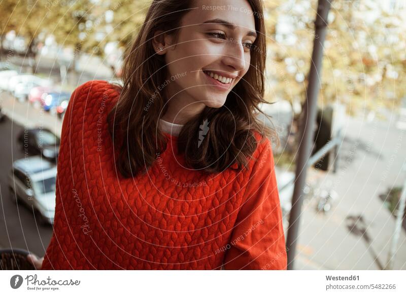 Smiling young woman on balcony looking sideways portrait portraits smiling smile females women Adults grown-ups grownups adult people persons human being humans