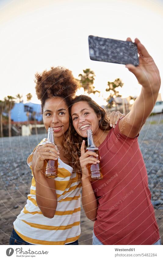 Two best friends taking selfie on the beach Beer Beers Ale beaches bff Selfie Selfies Alcohol alcoholic beverage Alcoholic Drink Alcoholic Drinks