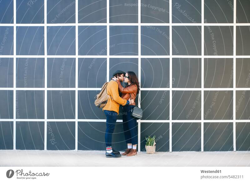 Kissing young couple kissing kisses twosomes partnership couples people persons human being humans human beings opposite standing in love wall walls pattern