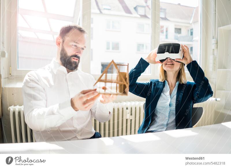 Woman and man with house model and VR glasses in office Businessman Business man Businessmen Business men businesswoman businesswomen business woman