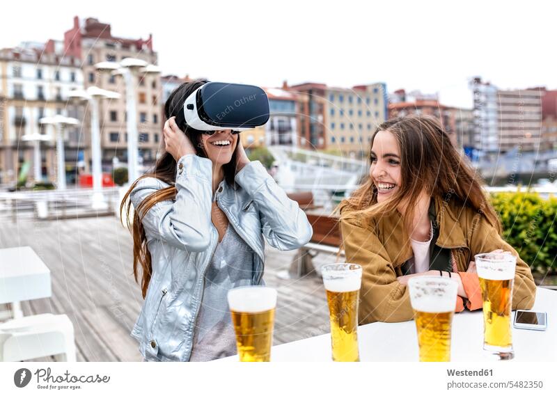 Two young women having fun with VR glasses in the city Virtual Reality Glasses Virtual-Reality Glasses virtual reality headset vr headset vr goggles