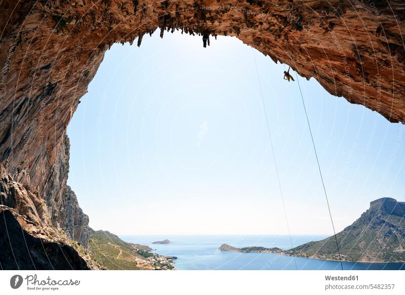 Greece, Kalymnos, climber abseiling in grotto climbing rock face rock wall escarpment rocks one person 1 one person only only one person rope ropes