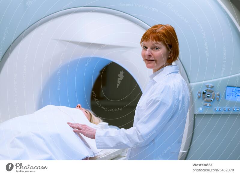 Female doctor preparing patient for magnetic resonance imaging Female Doctor physicians Female Doctors result finding results diagnosis diagnoses MRT