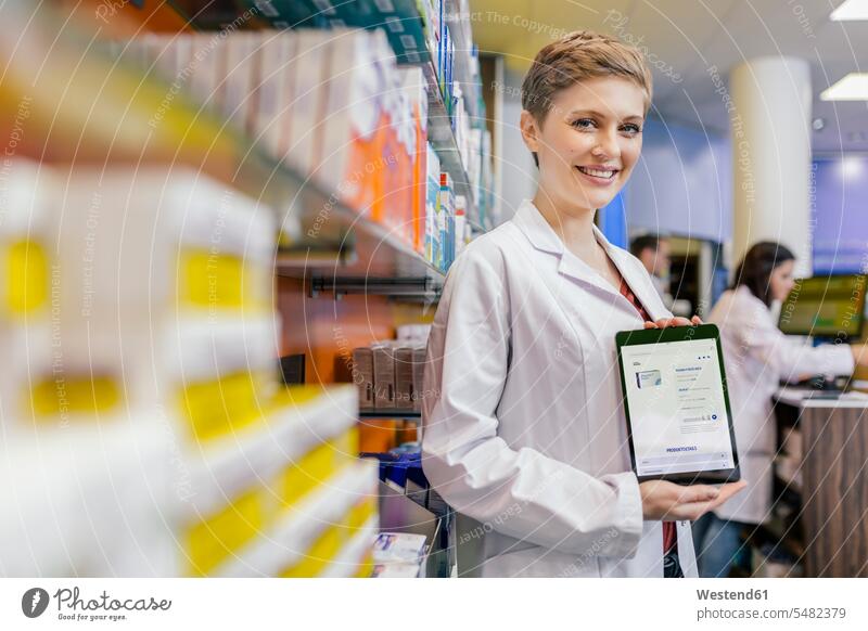 Portrait of smiling pharmacist in pharmacy holding tablet with digital order digitizer Tablet Computer Tablet PC Tablet Computers iPad Digital Tablet