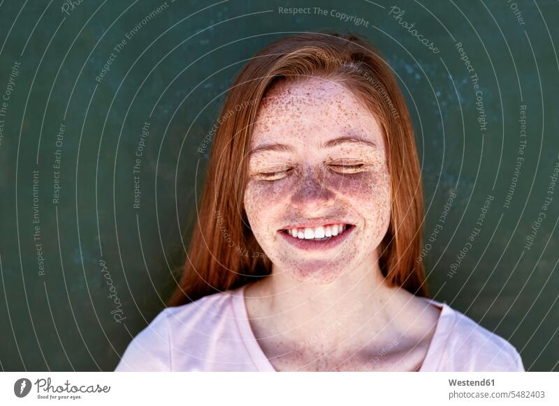 Portrait of smiling young woman with freckles closing her eyes portrait portraits smile females women freckled Adults grown-ups grownups adult people persons