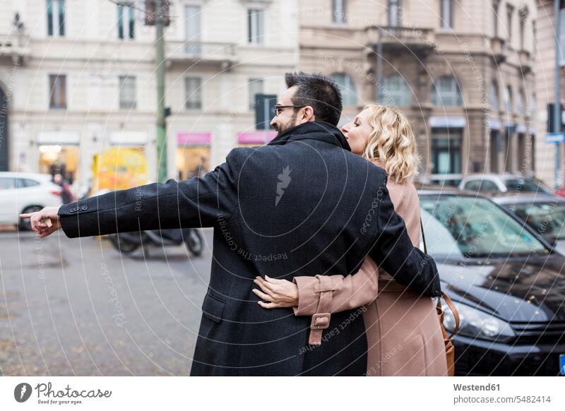 Business couple embracing in the city businesswoman businesswomen business woman business women Businessman Business man Businessmen Business men twosomes