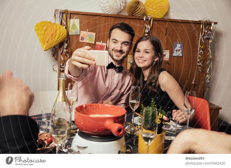 Friends taking selfies with smart phone on New Year's Eve caucasian caucasian ethnicity caucasian appearance european self-portrait Self Portrait Photography