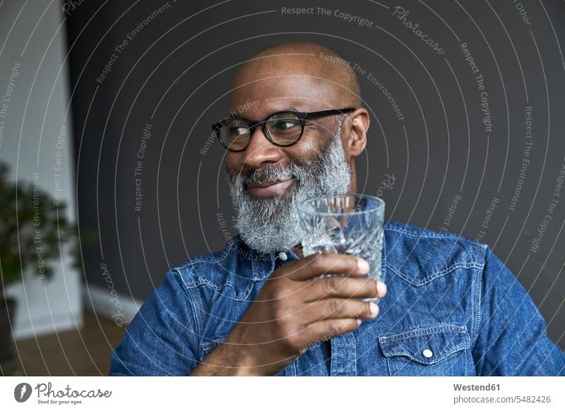 Mature man holding glass of water relaxed relaxation open-minded Openness open-mindedness openminded openmindedness Glass Drinking Glasses men males home