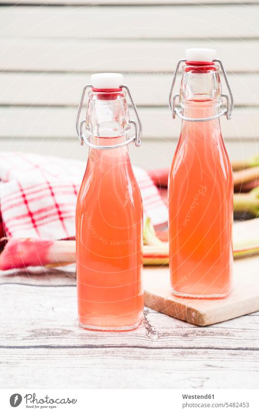 Two glass bottles of homemade rhubarb juice food and drink Nutrition Alimentation Food and Drinks home made home-made Juice Juices sirup syrup swing top bottle
