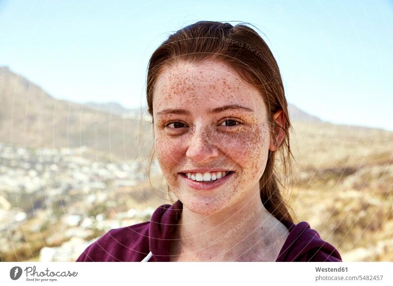 Portrait of smiling young woman with freckles outdoors portrait portraits freckled smile females women Adults grown-ups grownups adult people persons