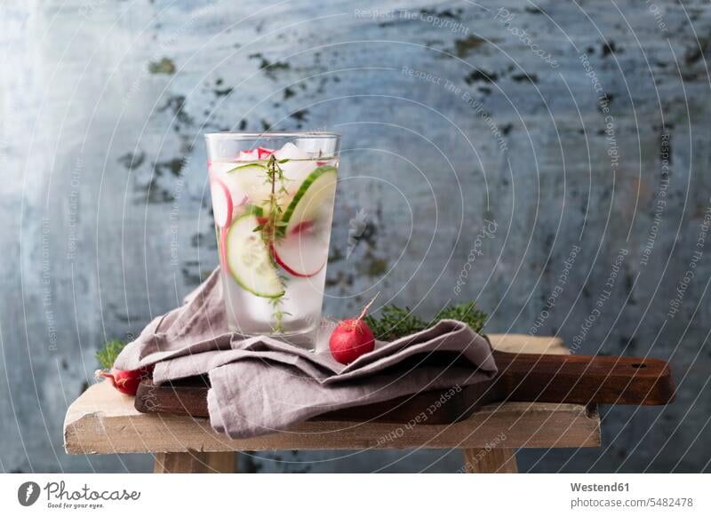 Water with thyme, cucumber and red radish, ice-cooled iced nobody stool stools copy space kitchen towel Glass Drinking Glasses water Chopping Board