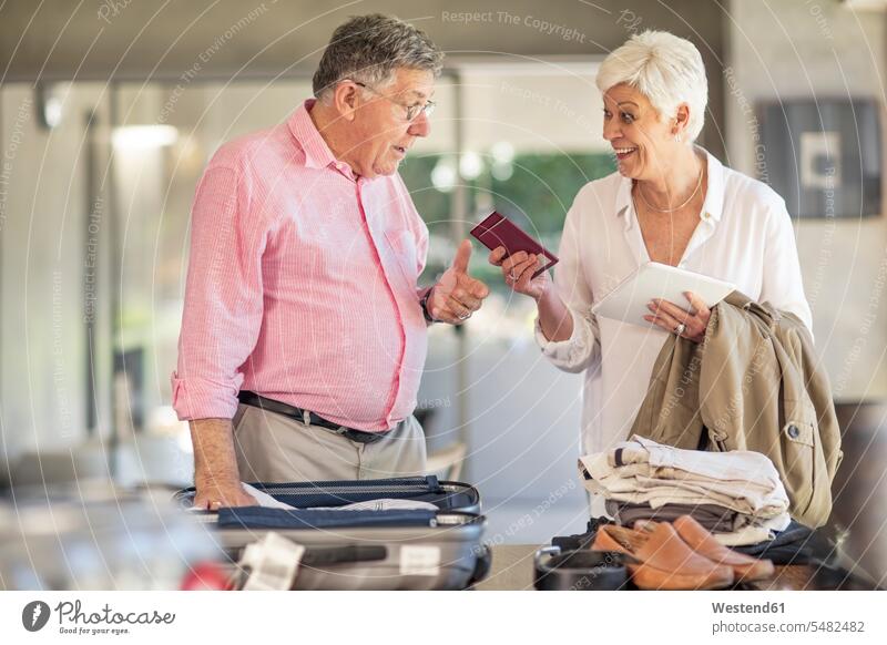 Senior couple packing for a trip together twosomes partnership couples senior men senior man elder man elder men senior citizen vacation Holidays people persons