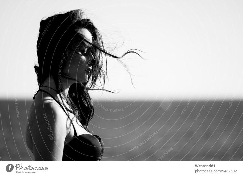 Spain, Tenerife, profile of woman with blowing hair in front of the sea caucasian caucasian ethnicity caucasian appearance european journey travelling Journeys