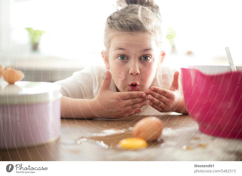 Portrait of embarrassed little girl in the kitchen females girls portrait portraits baking bake child children kid kids people persons human being humans