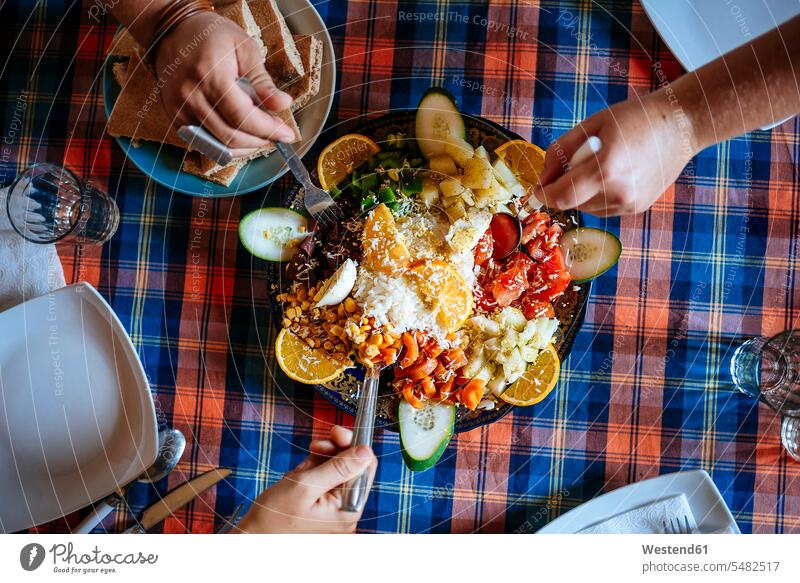 Three people eating Moroccan salad together, partial view hand human hand hands human hands Salad Salads persons human being humans human beings Food foods