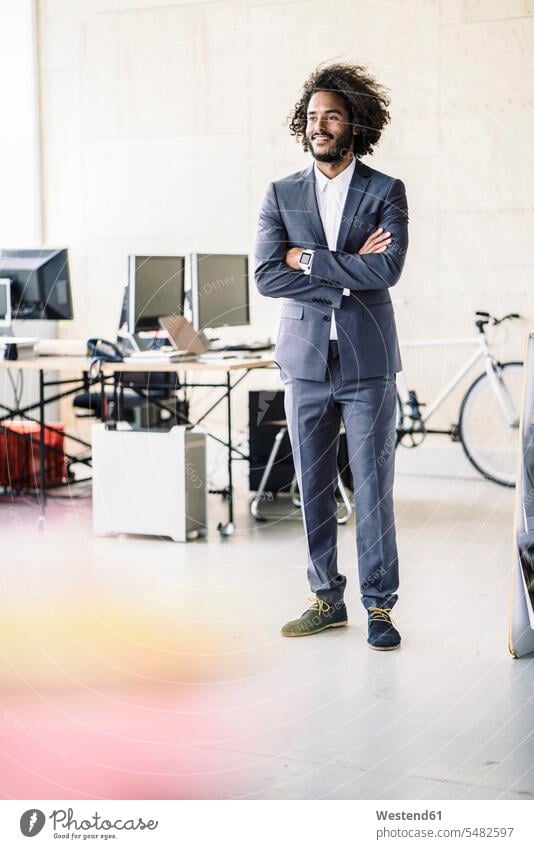 Young businessman standing in his office business life business world business person businesspeople Business man Business men Businessmen start up start-up