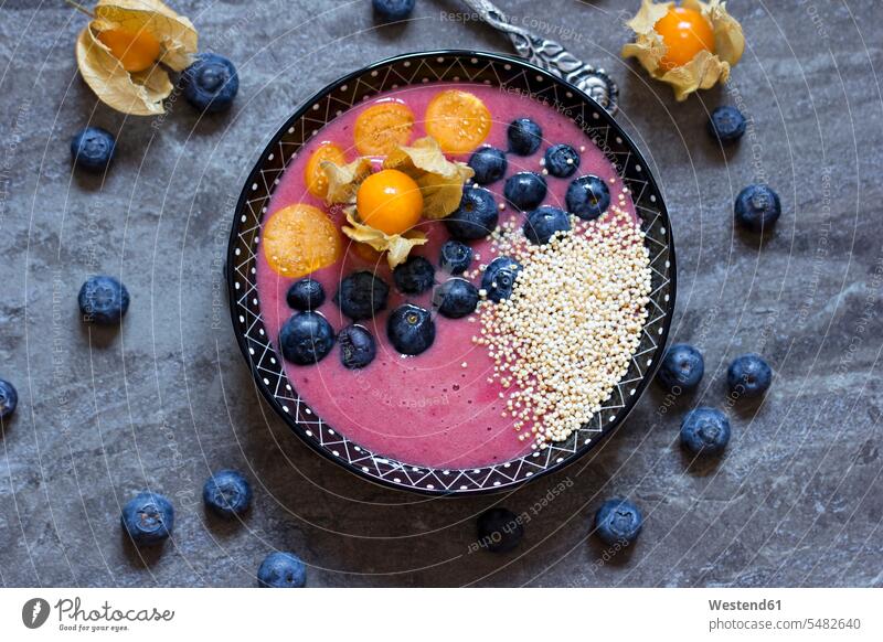 Bowl of blueberry smoothie with popped amarant, blueberries and physalis Bowls Physalis Cape gooseberry Physalis peruviana Cape gooseberries bilberry bilberries