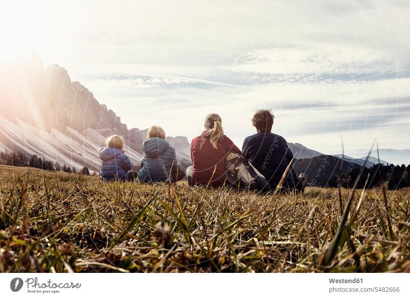 Italy, South Tyrol, Geissler group, family hiking, sitting on meadow families hiker wanderers hikers Looking At View Looking at a view excursion Getaway Trip