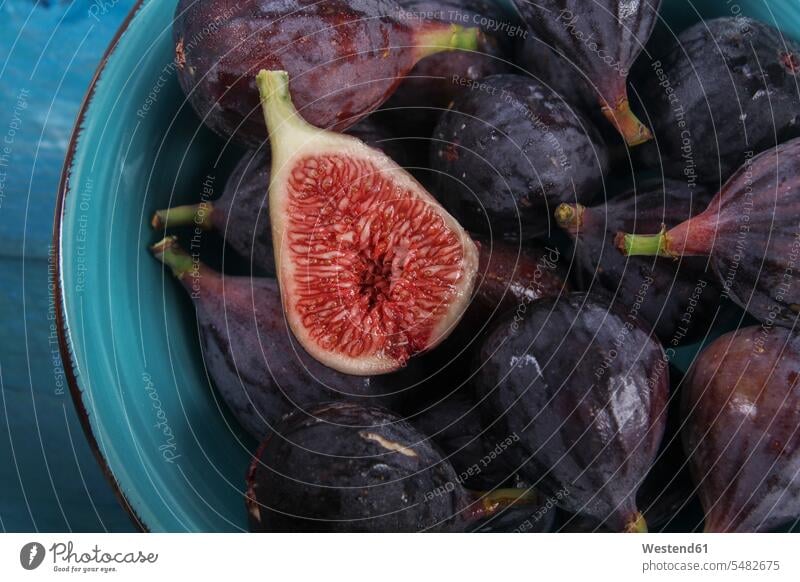 Sliced and whole figs in a bowl overhead view from above top view Overhead Overhead Shot View From Above wet wetness Part Of partial view cropped juicy close-up