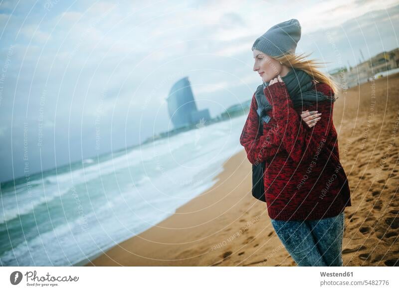 Spain, Barcelona, young woman on the beach in winter beaches females women Adults grown-ups grownups adult people persons human being humans human beings