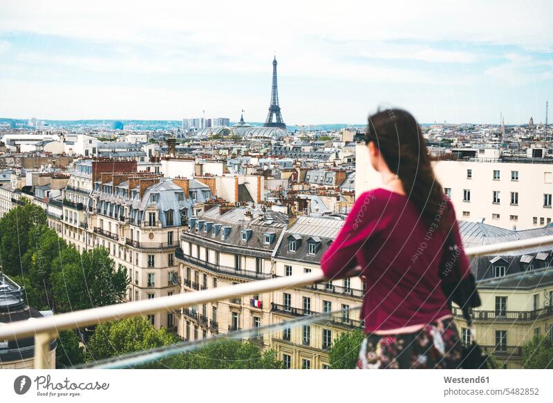 France, Paris, woman enjoying the view of Paris with the Eiffel Tower in the background caucasian caucasian ethnicity caucasian appearance european casual