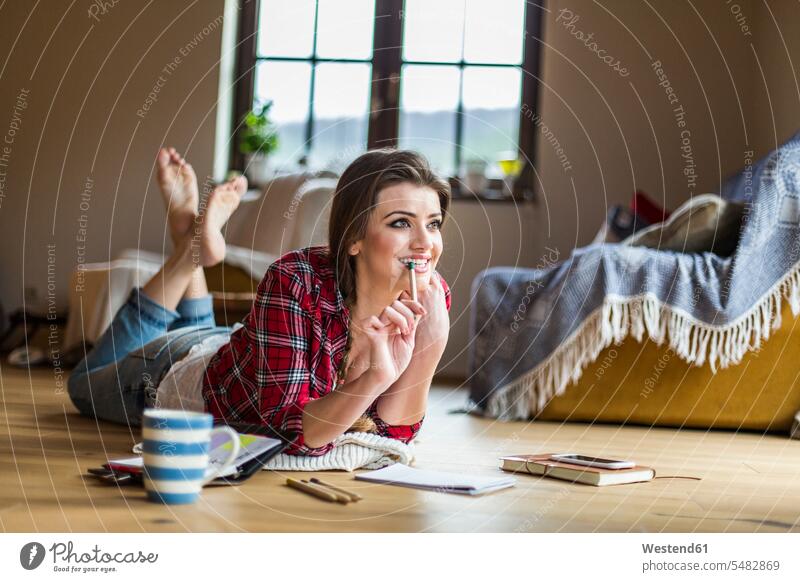 Young woman working at home caucasian caucasian ethnicity caucasian appearance european Floor Floors wooden floor wooden floors lying on front face-down
