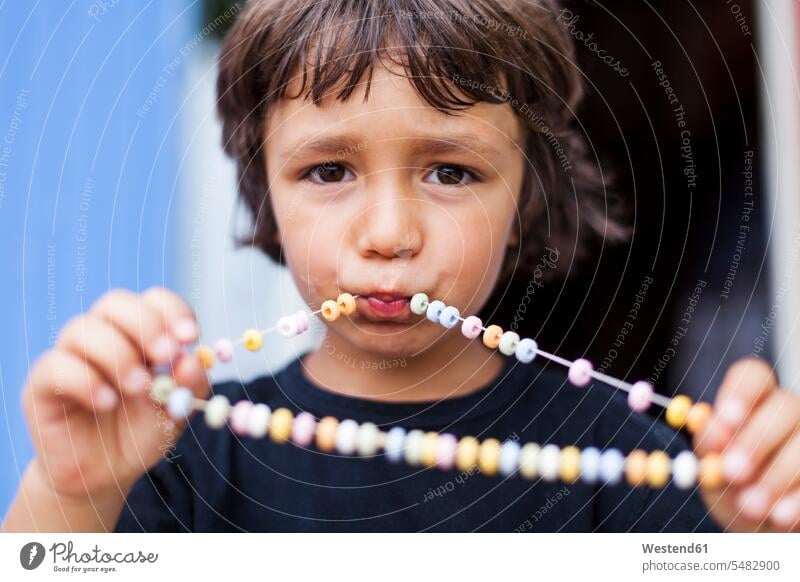Portrait of little boy with necklace of Hundreds and Thousands caucasian caucasian ethnicity caucasian appearance european sugar bead Nonpareils sugar beads