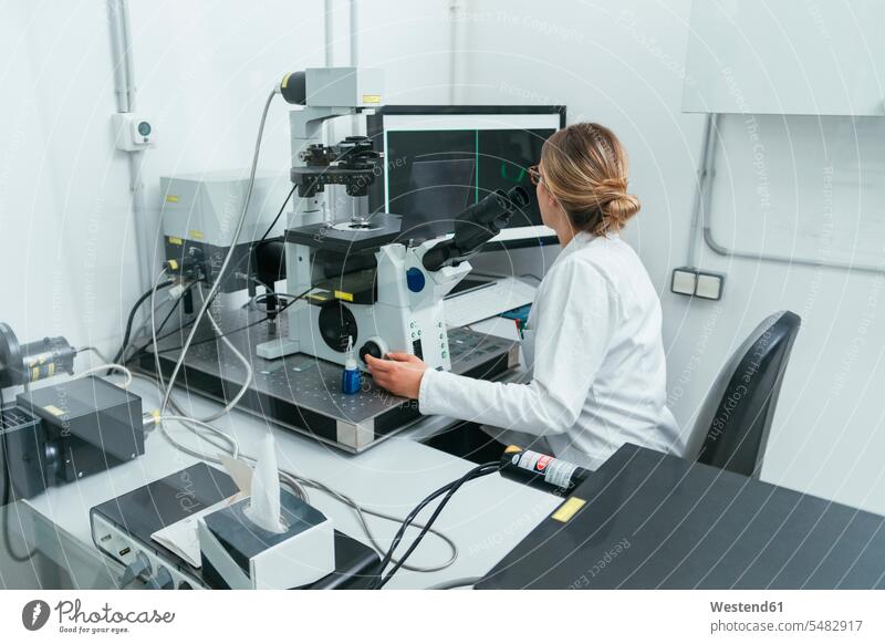 Laboratory technician working in modern lab laboratory examining checking examine woman females women laboratory technician At Work workplace work place
