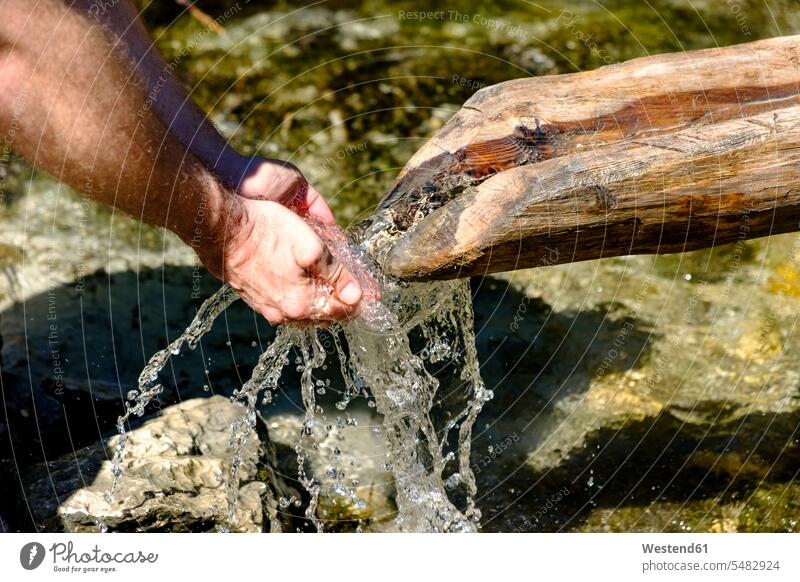 Hands of man drinking water from a source, close-up hand human hand hands human hands spring springs wells people persons human being humans human beings waters