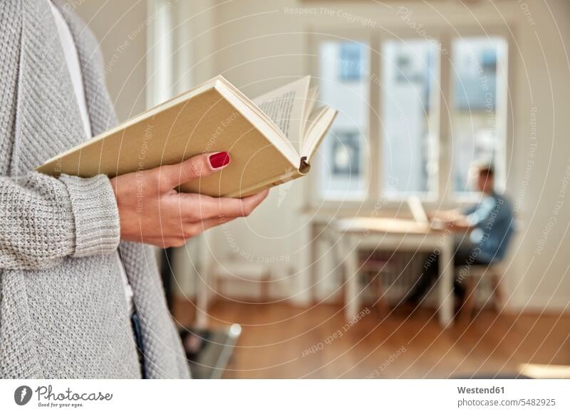 Hands of woman holding open book hand human hand hands human hands books people persons human being humans human beings reading relaxation relaxed relaxing