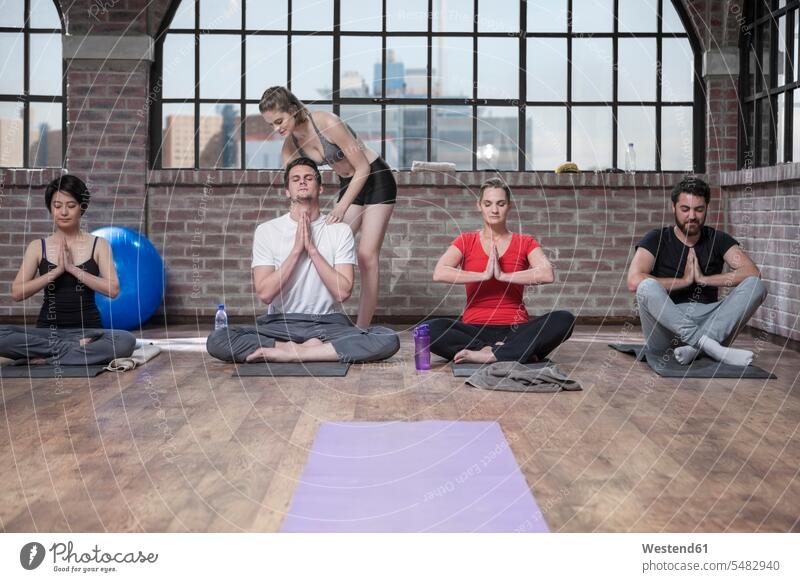 Woman instructing yoga class exercise exercises sitting Seated group of people Group groups of people coach coaches trainer persons human being humans
