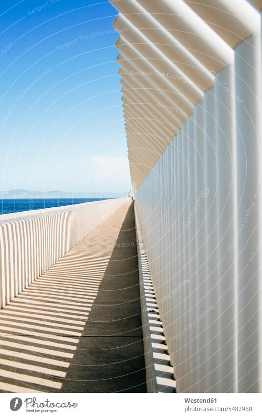 Spain, Andalusia, Tarifa, Light and shadows created by a fence on a concrete surface coast coastline coast area Seacoast seaside vastness wide Broad Far