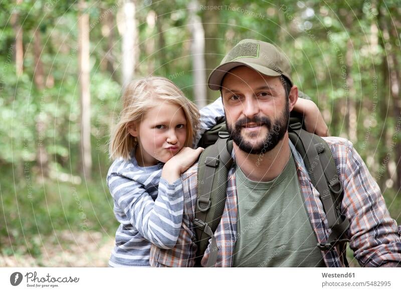 Portrait of smiling father and daughter in forest woods forests girl females girls pa fathers daddy dads papa daughters portrait portraits smile child children