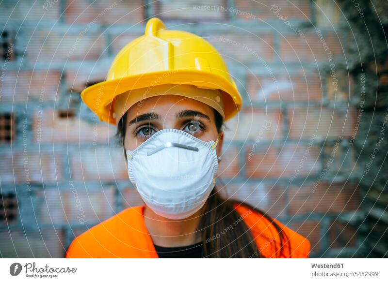 Portrait of woman wearing dust mask females women working At Work construction site Building Site sites Building Sites construction sites Adults grown-ups