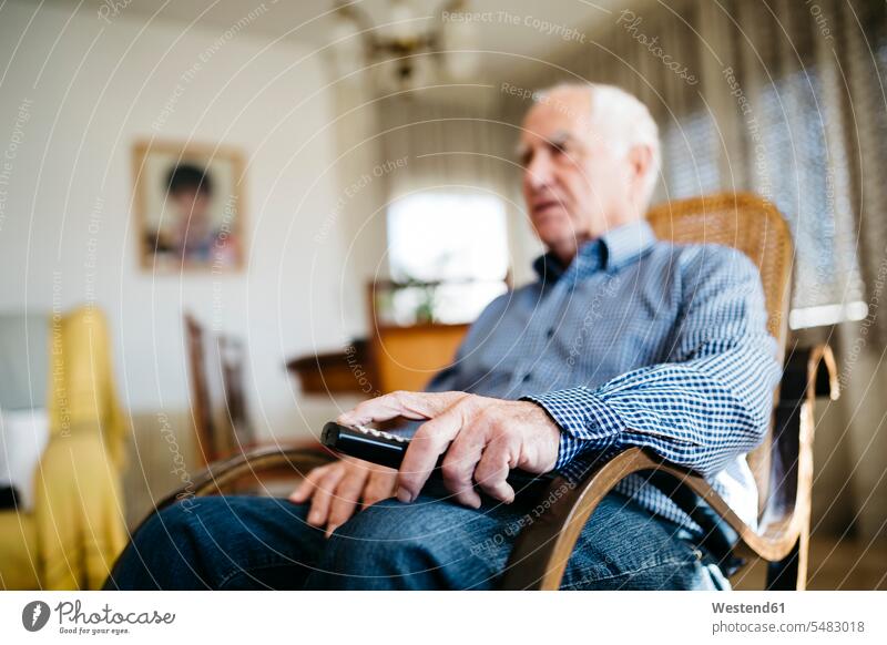 Hand of senior man holding remote control, close-up caucasian caucasian ethnicity caucasian appearance european low angle view worm's eye view bottom view