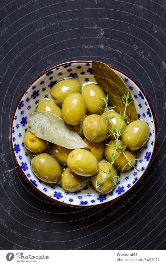 Green olives thyme and bay leaves in bowl food and drink Nutrition Alimentation Food and Drinks outdoors outdoor shots location shot location shots