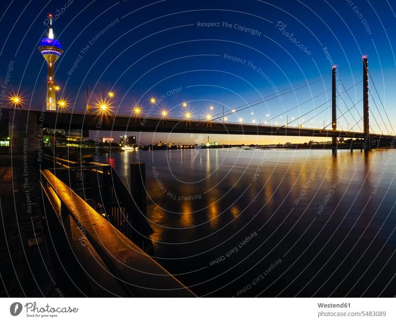 Germany, Duesseldorf, view to lighted Rheinknie-Bruecke and television tower by night illuminated lit Illuminating landmark sight place of interest