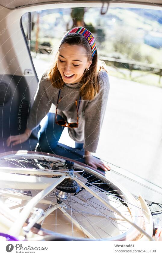 Young woman putting bicycle into car caucasian caucasian ethnicity caucasian appearance european European one person 1 one person only only one person