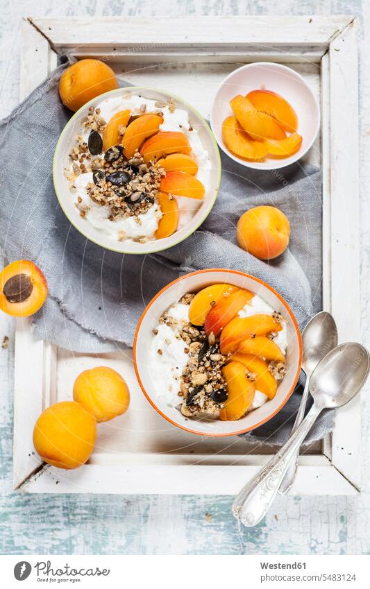 Yogurt with crunchy muesli and fresh apricot Granola Muesli cereals wooden tray food and drink Nutrition Alimentation Food and Drinks Yoghurt Yoghourt
